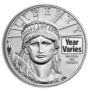 Close-up of a silver coin featuring the Statue of Liberty and a prominent 'Year Var ies' label, with 'IN GOD WE TRUST' nearby.