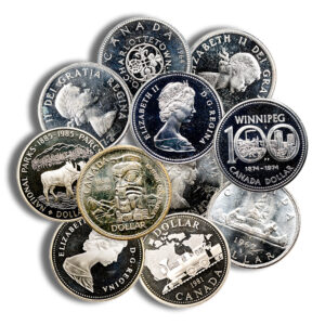 Collection of Canadian coins overlapping, featuring Queen Elizabeth II portraits and a Winnipeg 100-dollar commemorative coin on top of the pile.